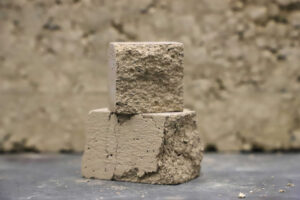 Symbol Image: two wet clay cubes on top of each other.